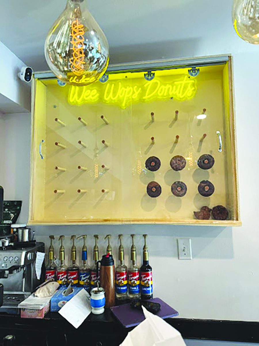 The wall art showcases the variety of specialty donuts they have available each day.